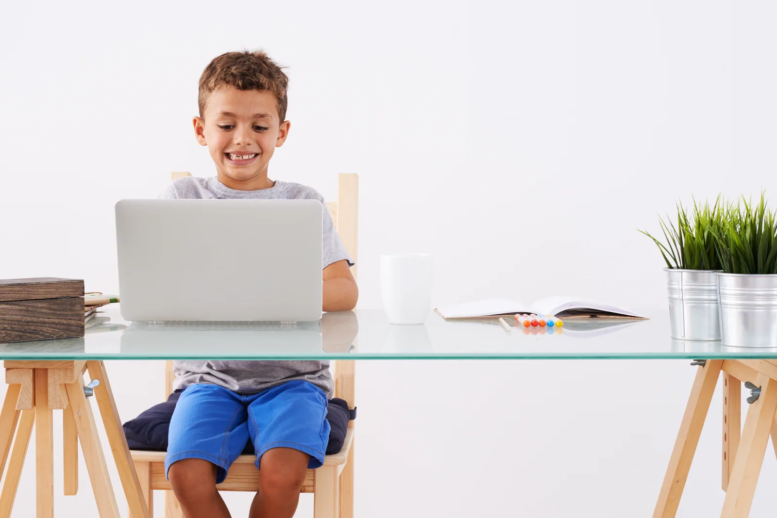 A young learner using a laptop for an online lesson