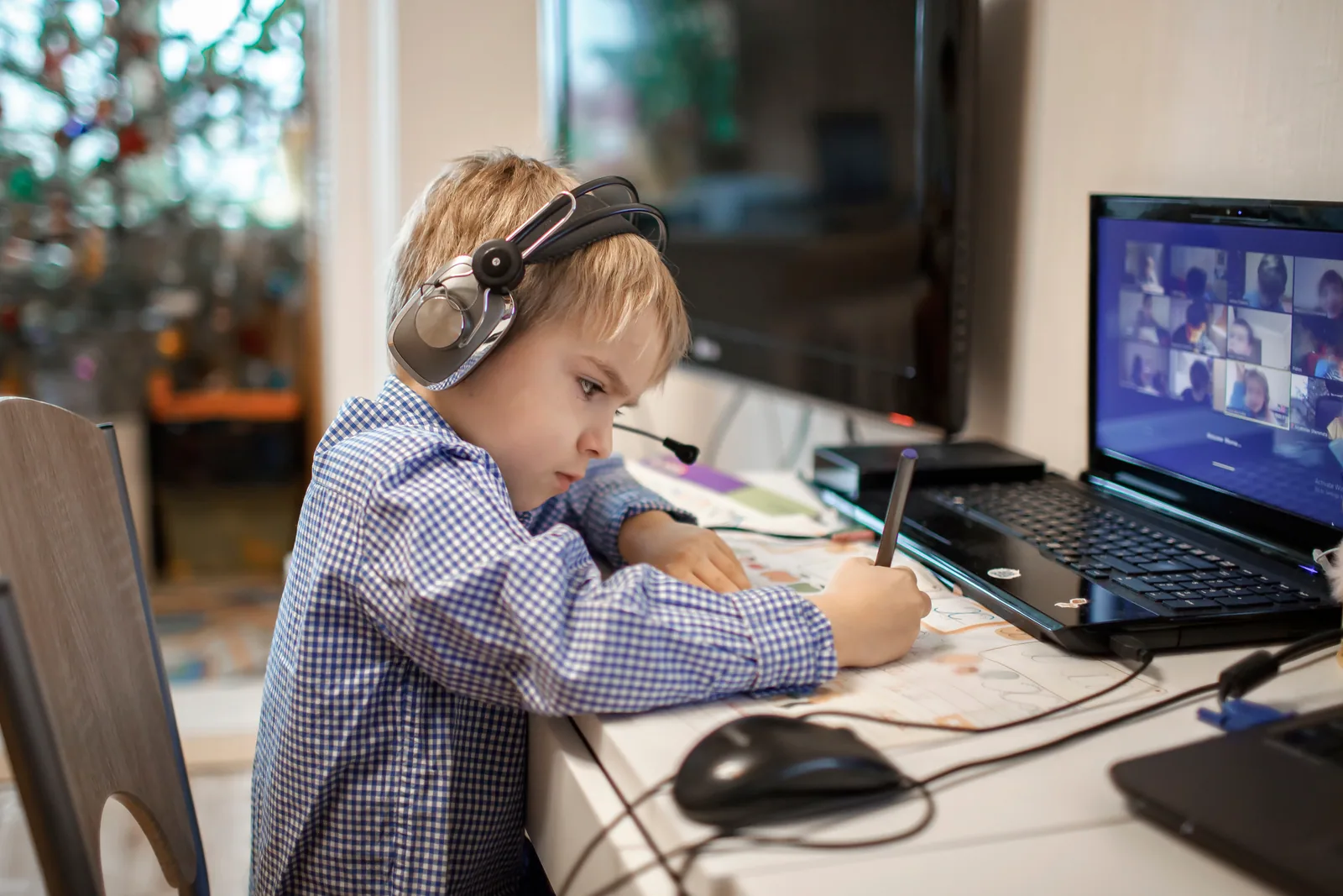 A child taking an online lesson at a laptop