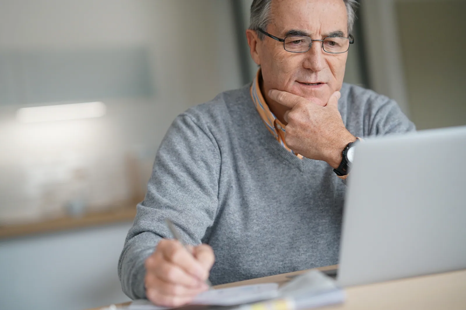 An older learner using a laptop at home