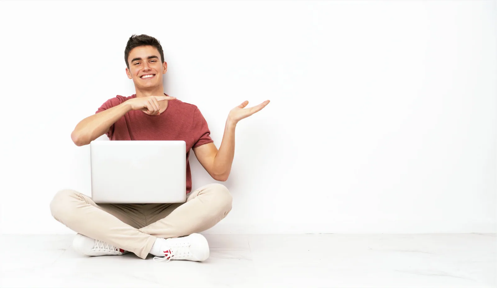 An A-Level student sitting with a laptop