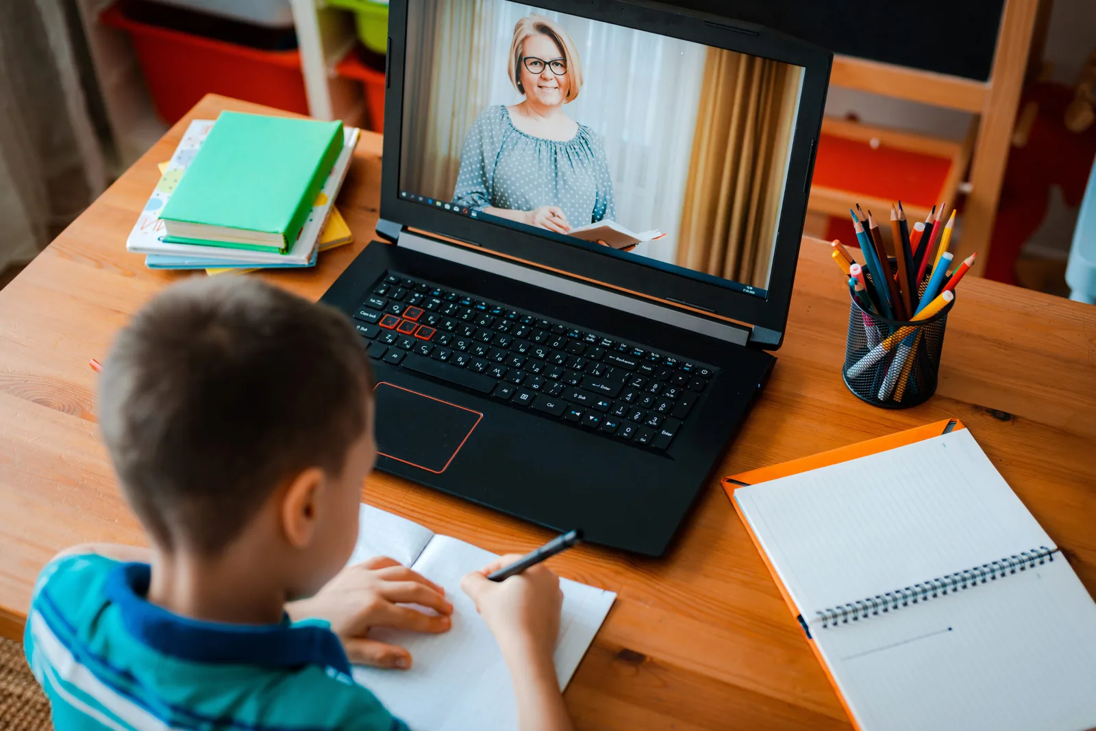 A child doing schoolwork at home with a laptop