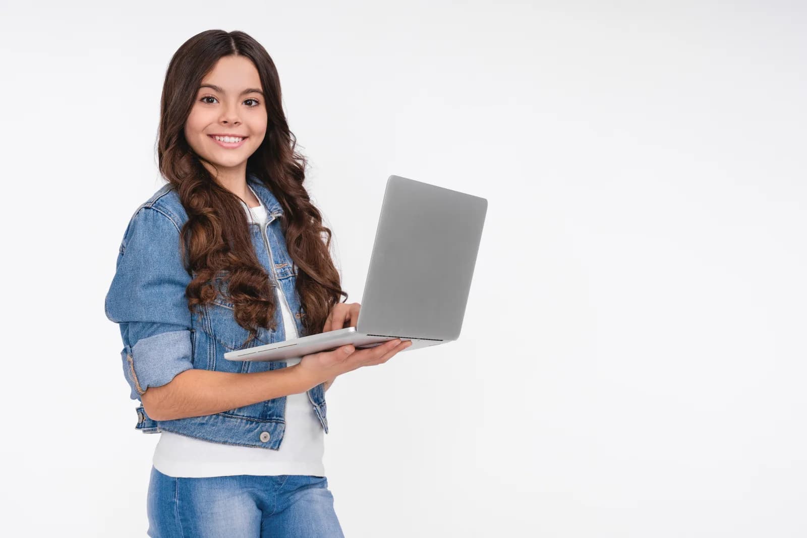 A GCSE student smiling with a laptop