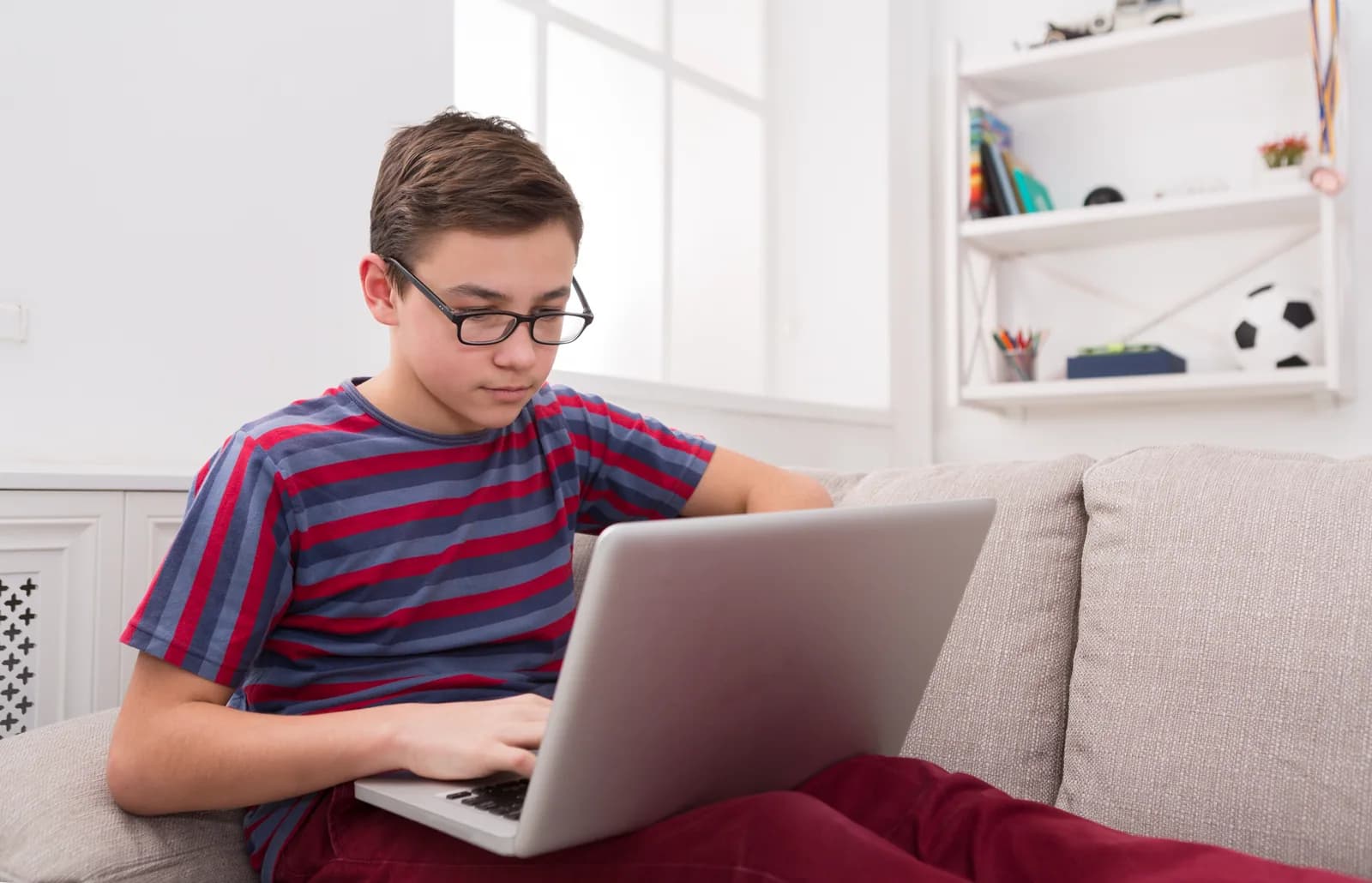 A student studying with a laptop at home